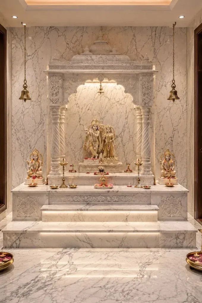 Design concept: marble pooja room with a carved mandir, twisted columns, lit steps and brass bells